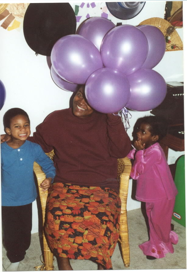 Mommy hides under balloons.