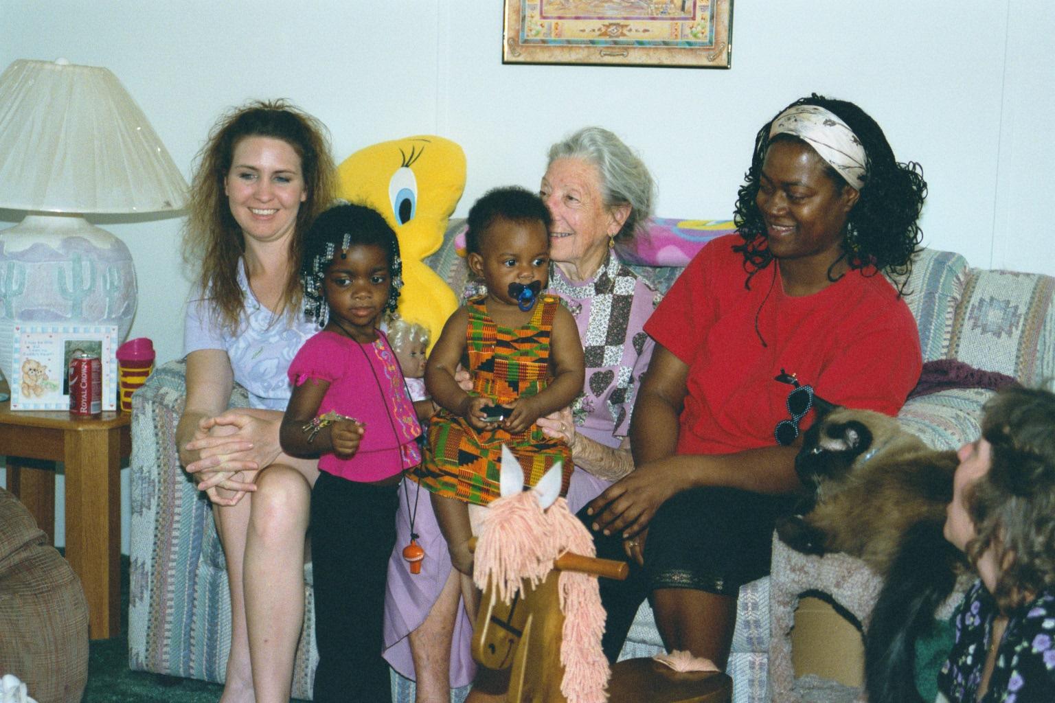 In Shannon's living room Shannon, Blessin,Fortune on Grandma's lap, and Mommy. Cherilyn looks on.