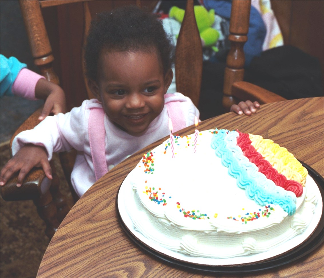 Fortune has a candle for each year on a colorful cake.