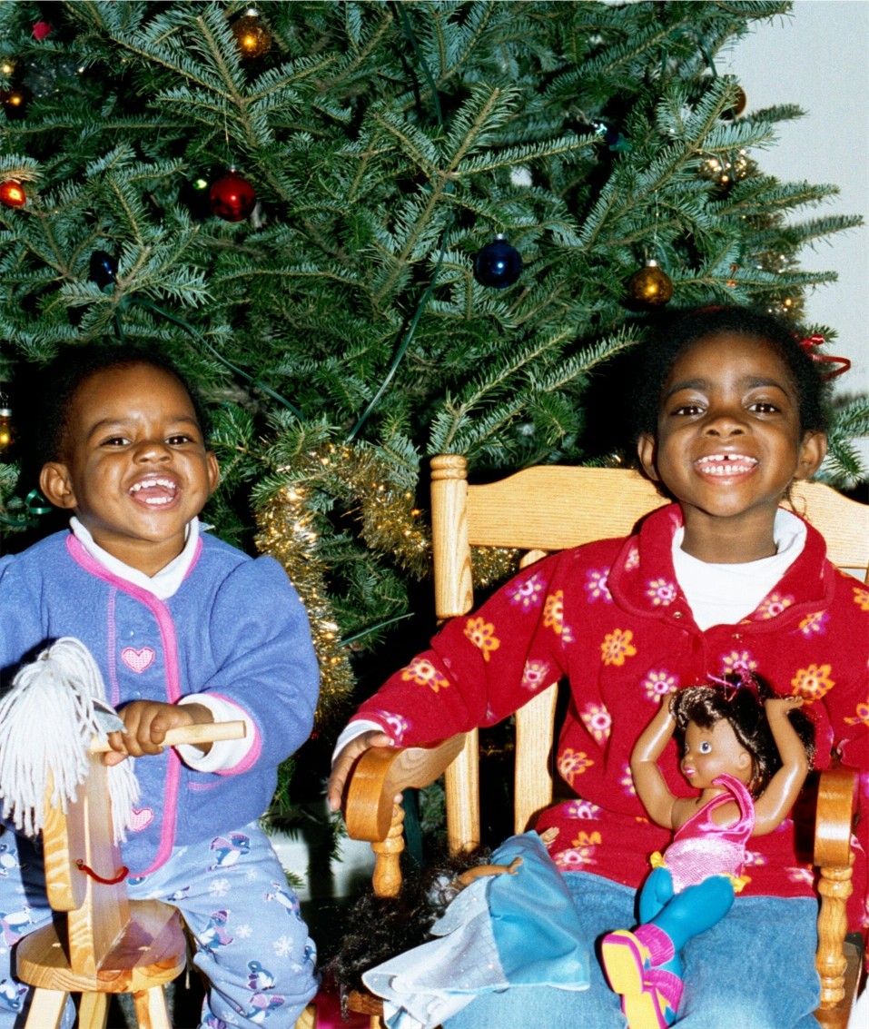 Blessin and Fortune Rock and laugh in front of the tree.