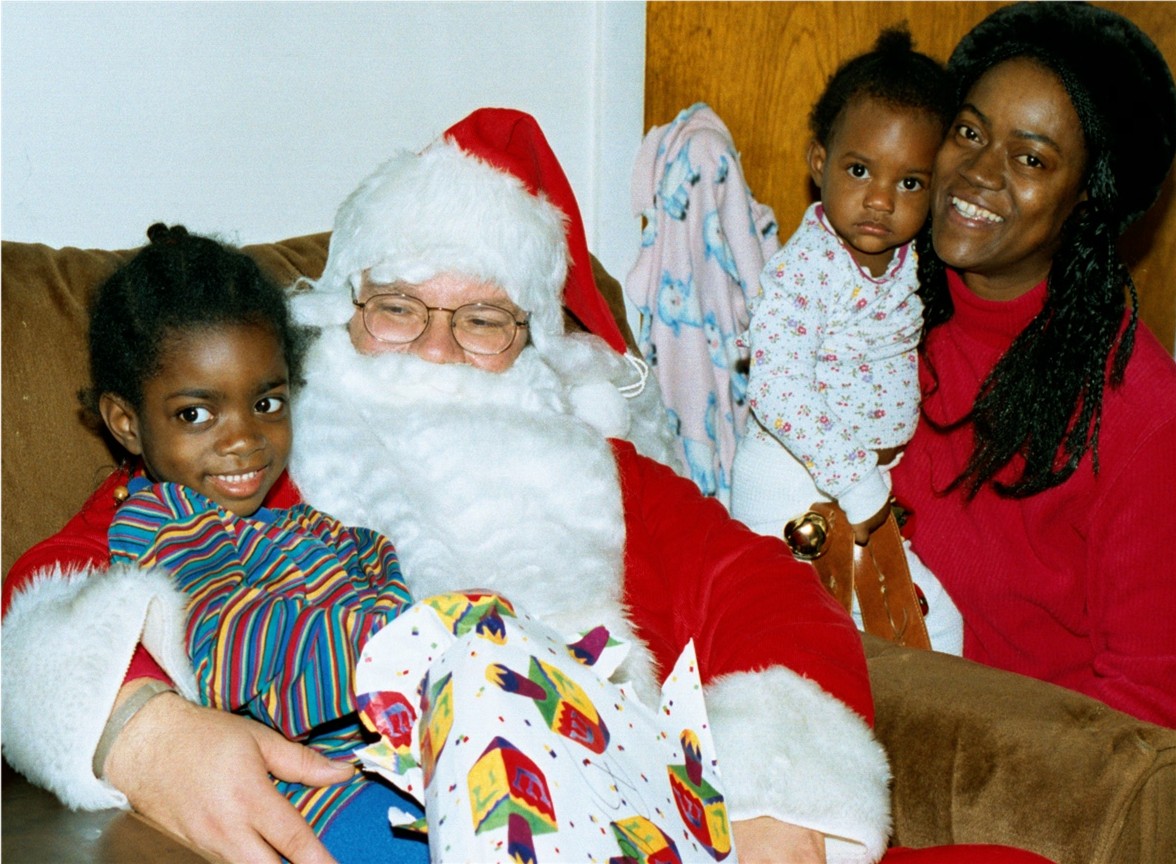 Blessin relaxed on Santa's lap while Fortune is reluctant.