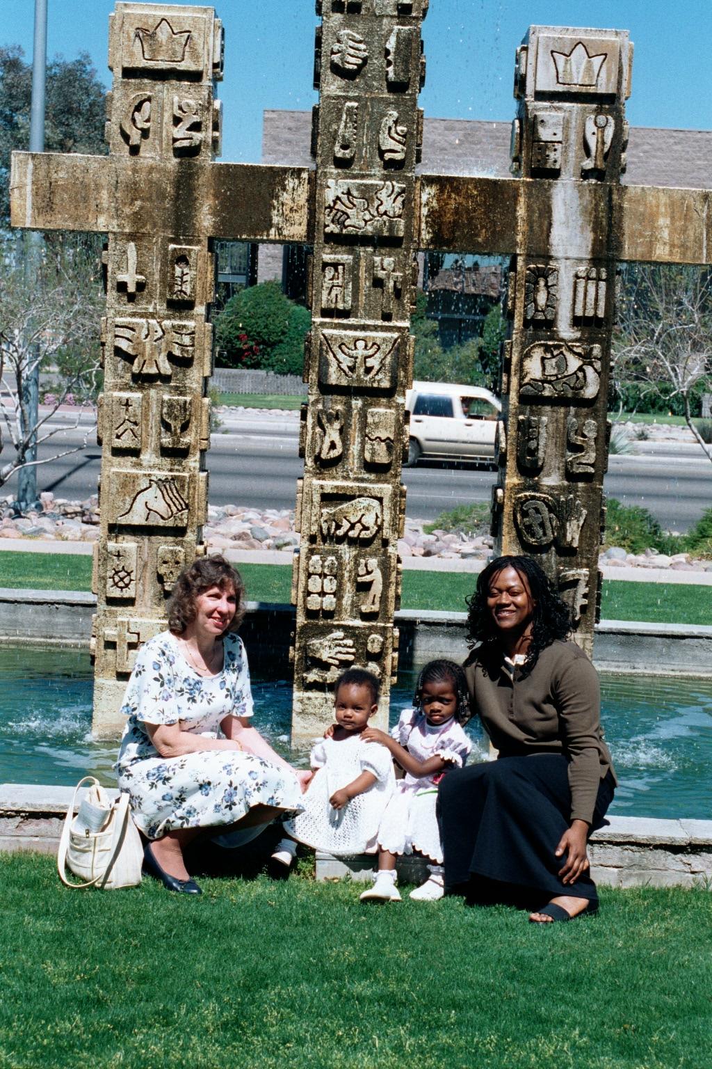 Grandma looks on while Mommy, Frotune Blessin and Aunt Cherilyn pose